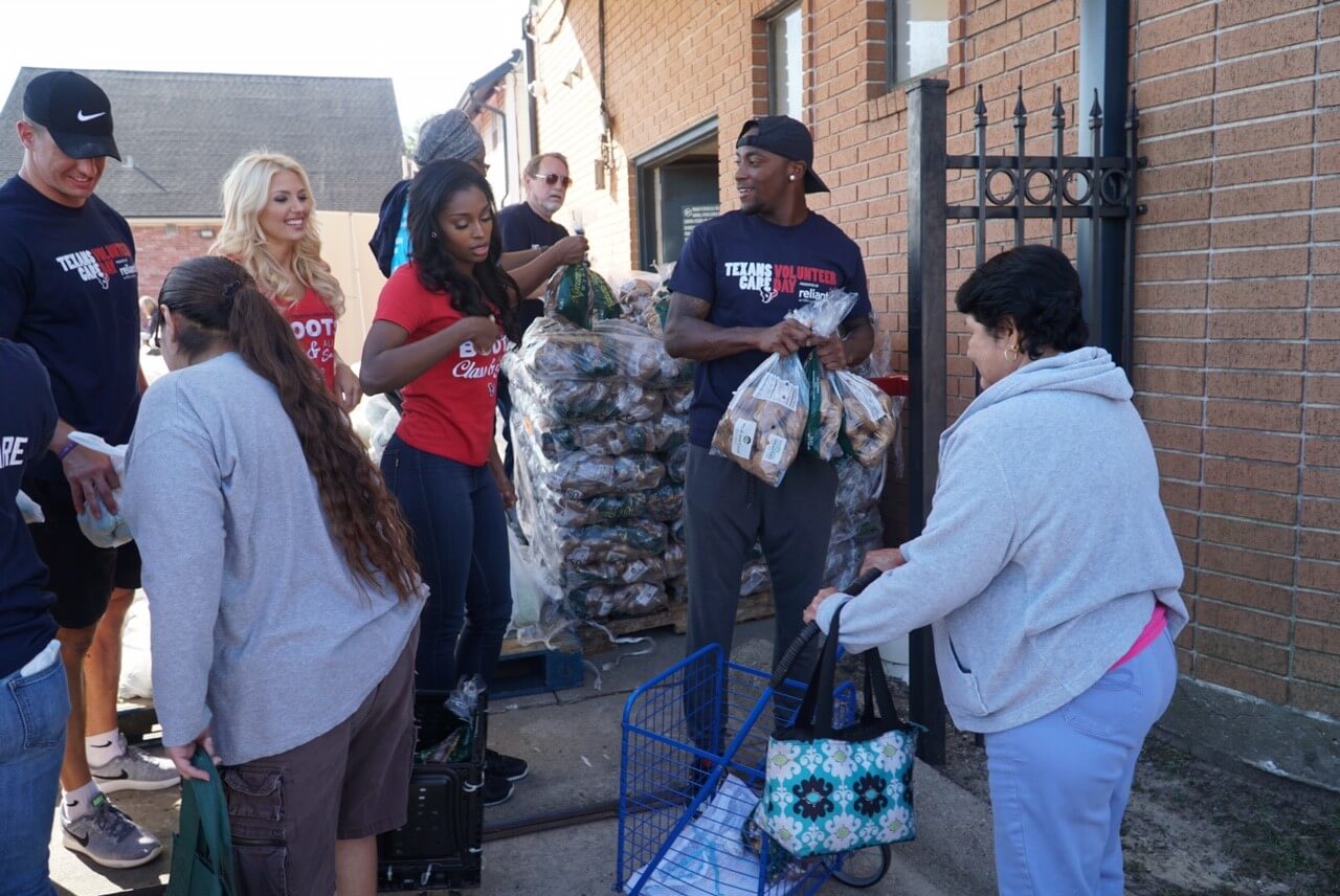 Texans pass out food to Catholic Charities clients