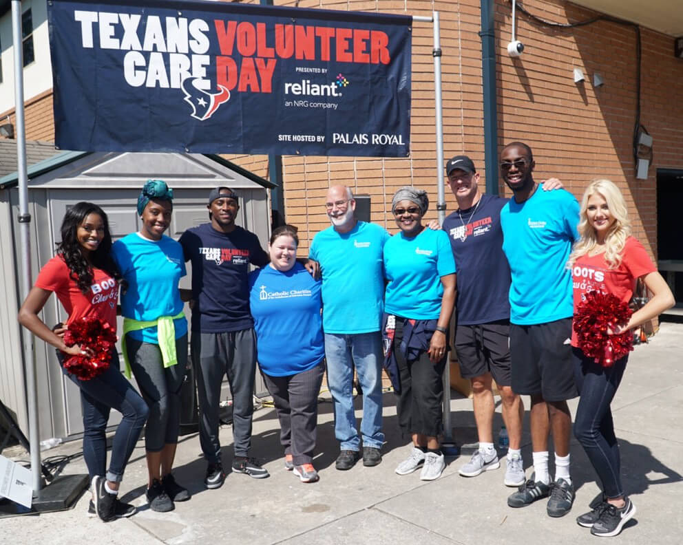 Houston Texans players and cheerleaders volunteered with Catholic Charities.