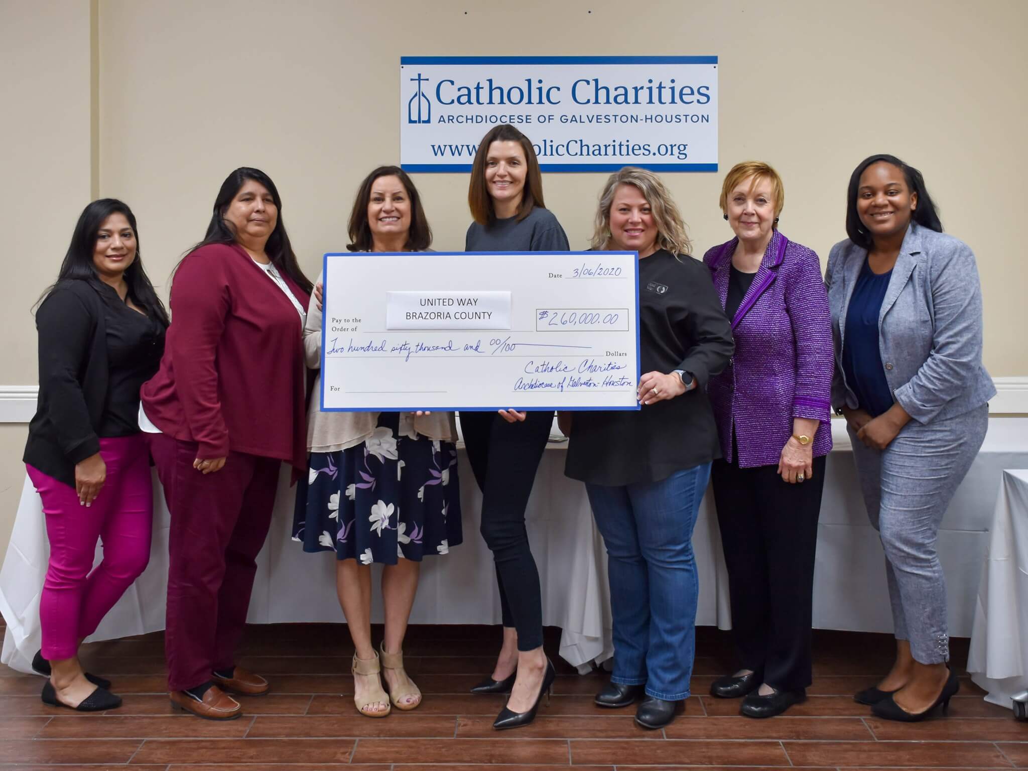 Catholic Charities presented a check to United Way Brazoria County and Brazoria County Long Term Recovery Committee.
