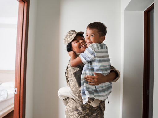 Black female soldier holds son on arms after army