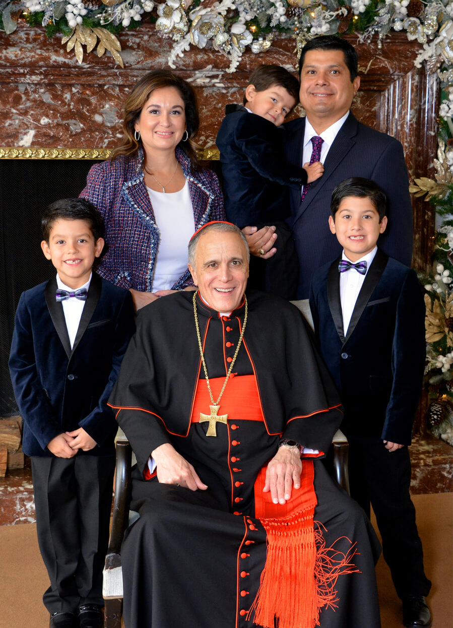 Event chairs Michelle and Stephen Fraga snap a photo with His Eminence Daniel Cardinal DiNardo at A Cardinal's Christmas. Pictured with their three children: Stephen Jr., Gregory and Andrew.