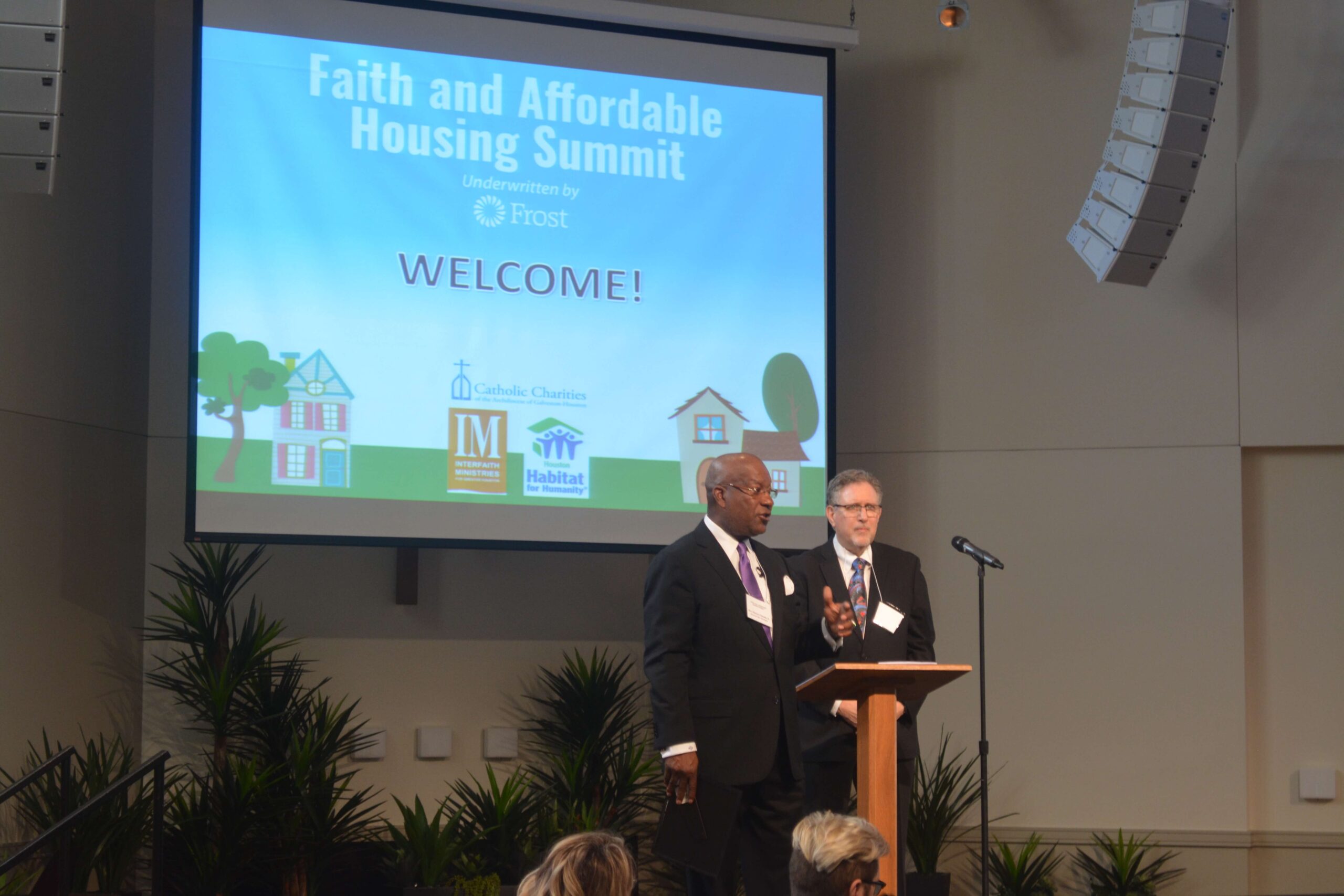 Rev. Harvey Clemons Jr. of Pleasant Hill Baptist Church and Steve Mikelman, Director of Housing and Economic Opportunities for Catholic Charities, address an audience of more than 100 faith and community leaders at the first-ever Faith and Affordable Housing Summit.