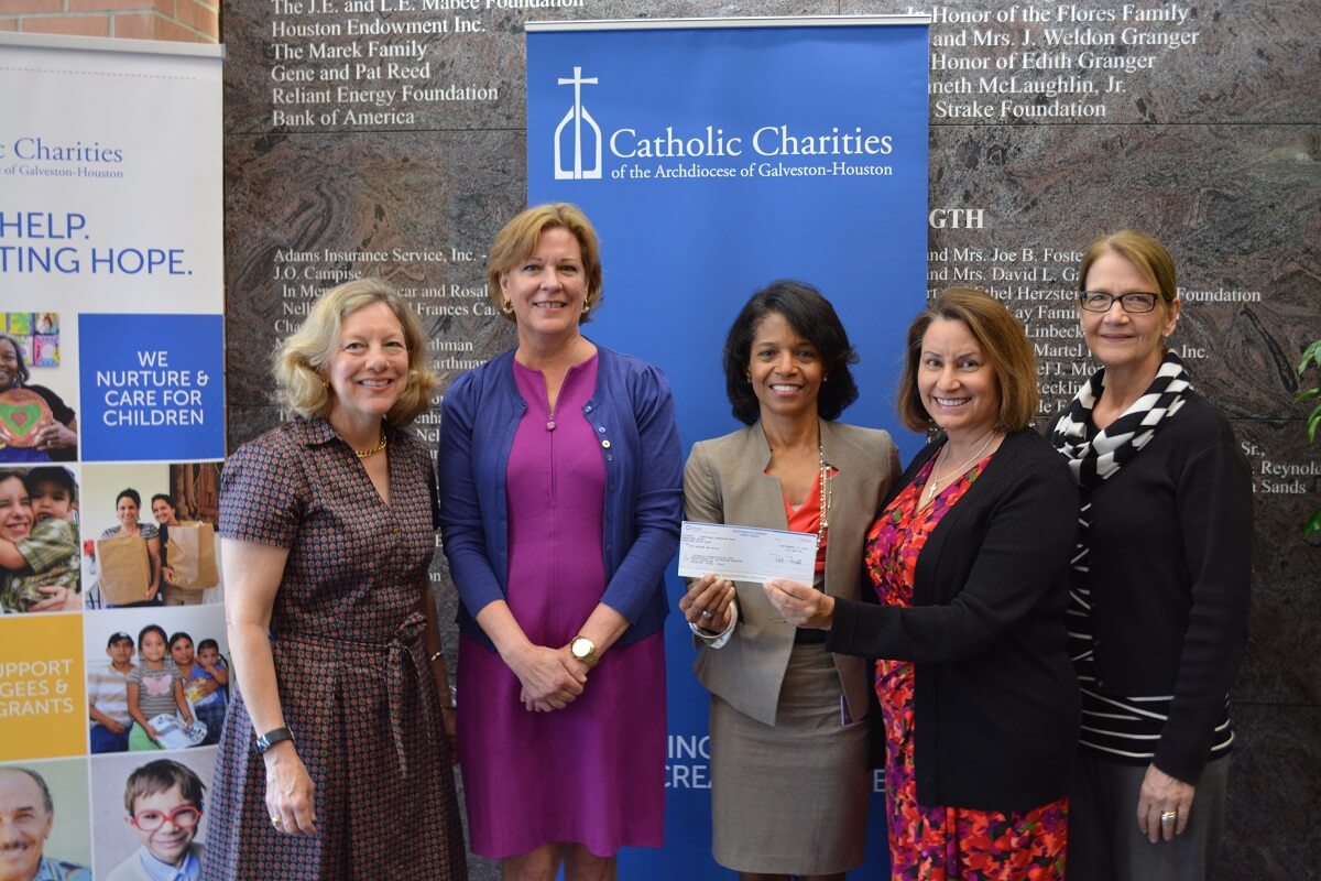 Frost Bank presents Catholic Charities with $10,000 for disaster relief.