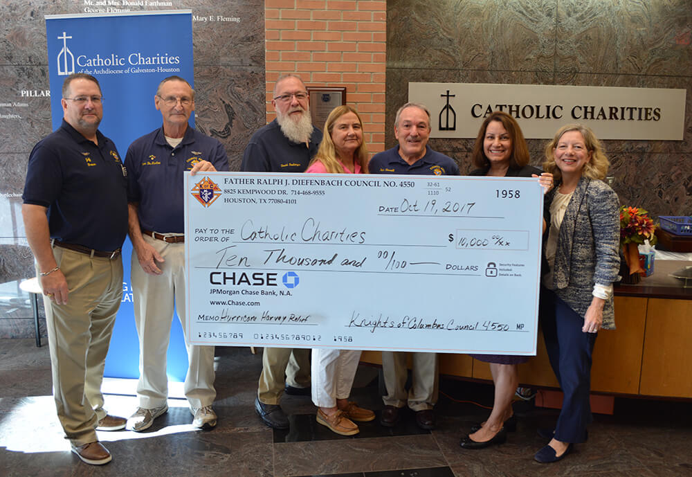 Knights of Columbus present a check to Catholic Charities for disaster relief.