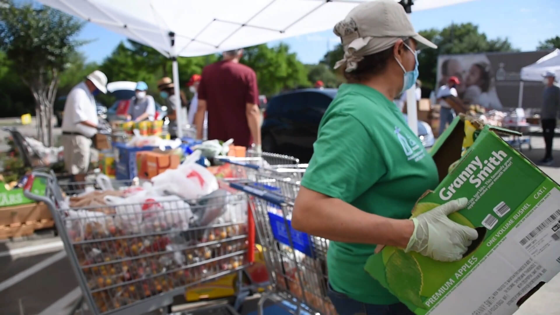 A volunteer helps at Catholic Charities' Mamie George Community Center food distribution.
