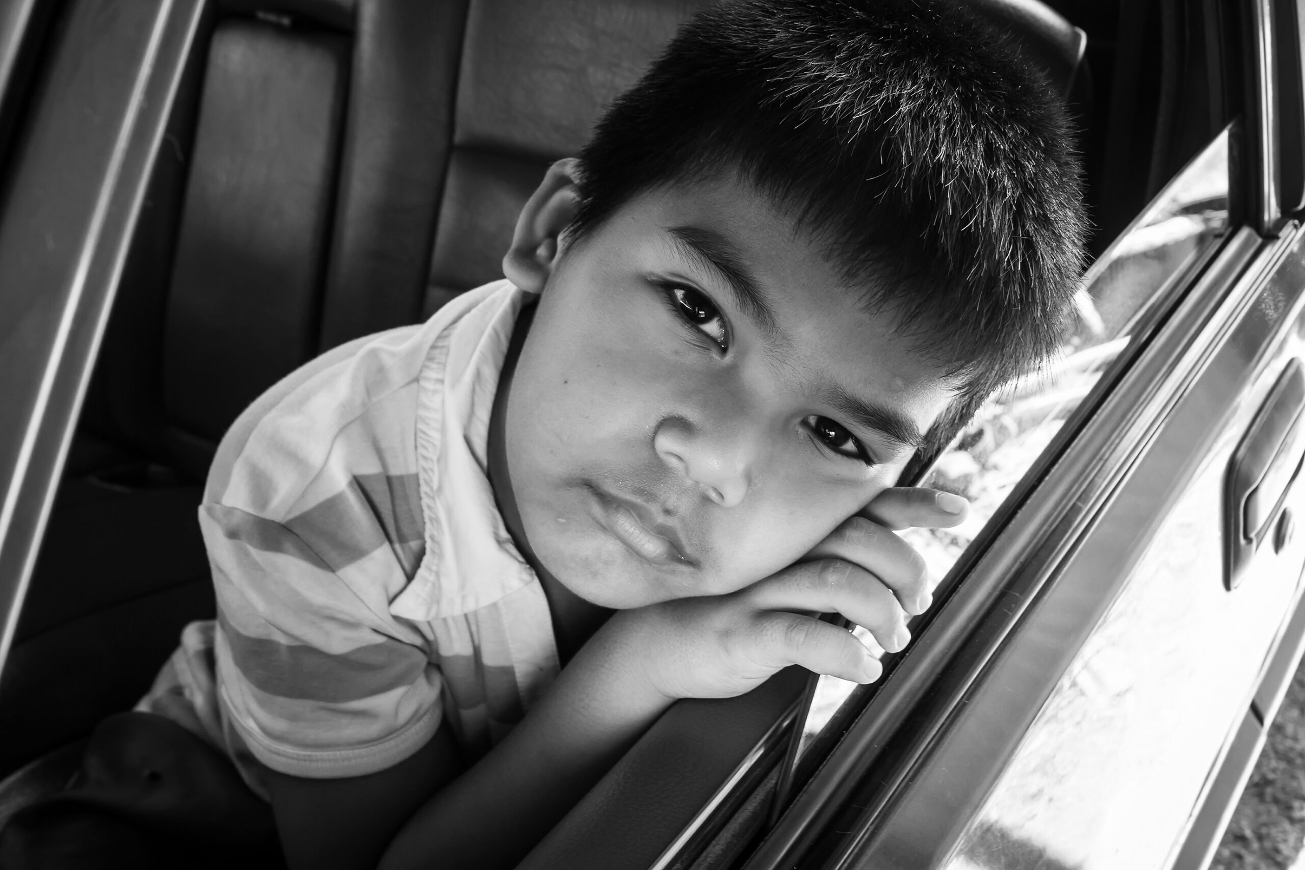 boy sad alone in the old car