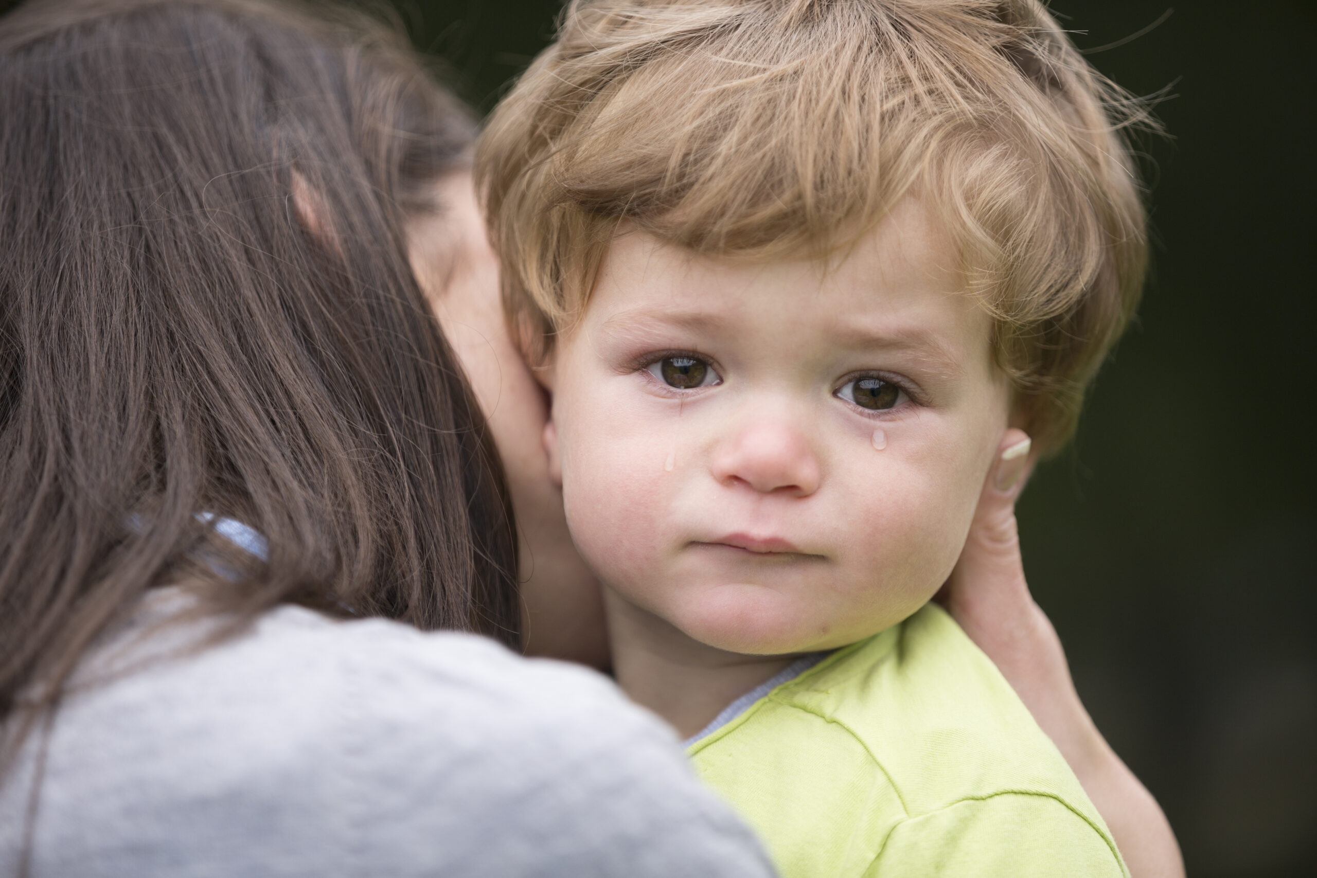 Sad little boy being hugged by his mother. Sad little boy being hugged by his mother.