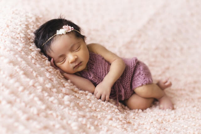 toddler lying on pink fleece pad 1442005